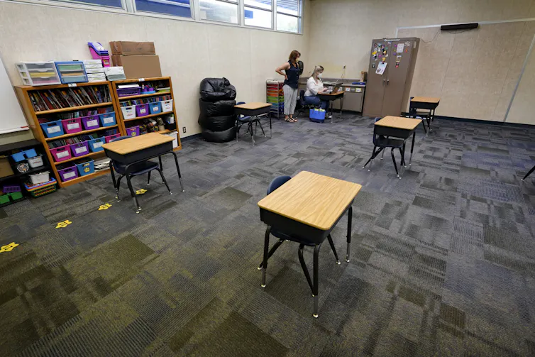 Desks spaced out in a classroom.