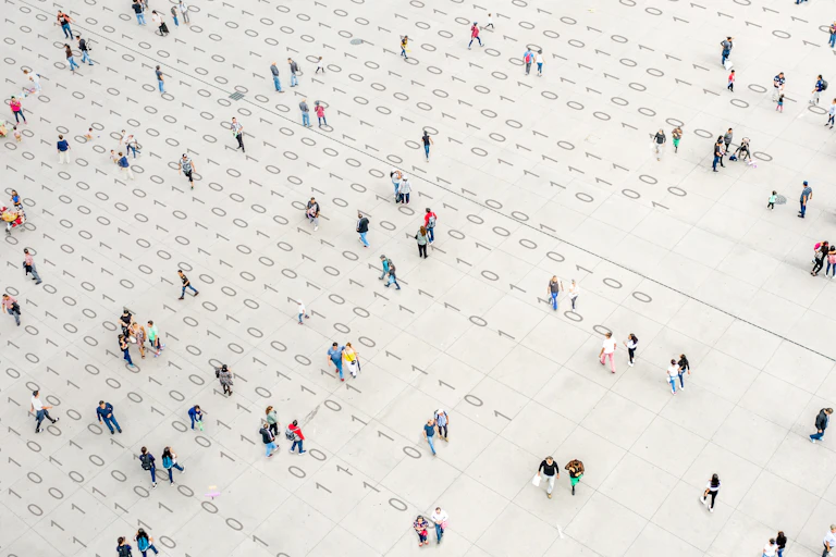 People walking over a white paper full of binary code.