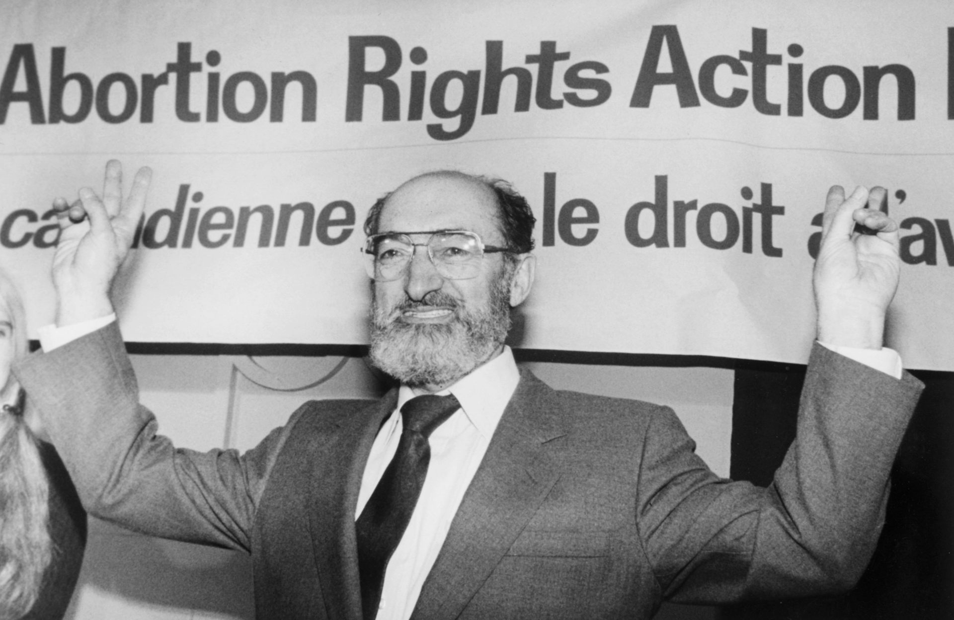 Dr. Henry Morgentaler raises his arms in victory.