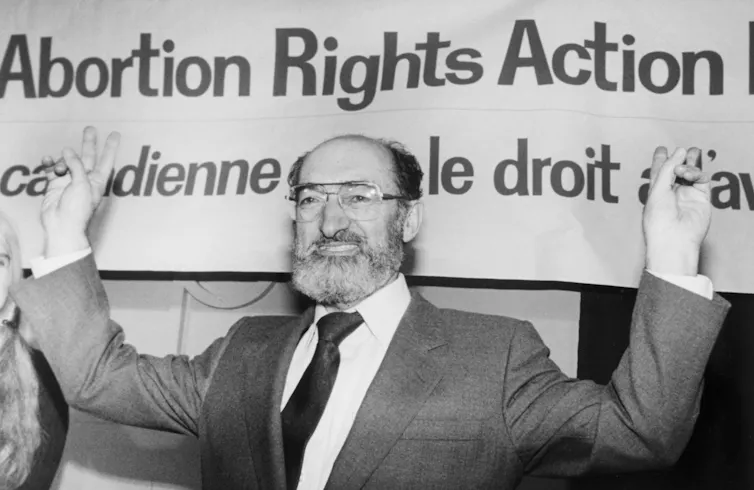 Dr. Henry Morgentaler raises his arms in victory.