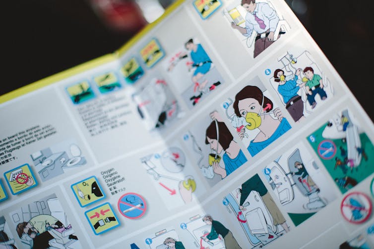 An airline safety brochure showing how adults should fit their oxygen masks first before helping children