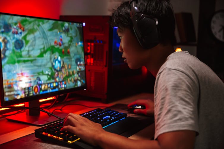 Teenage boy playing a computer game
