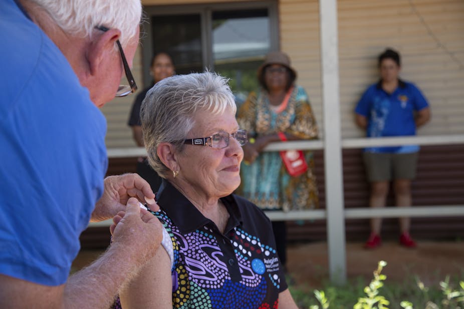 Aboriginal woman being vacinated.