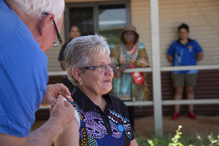 Aboriginal woman being vacinated.