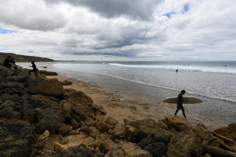 Surfer prepares to enter the water.