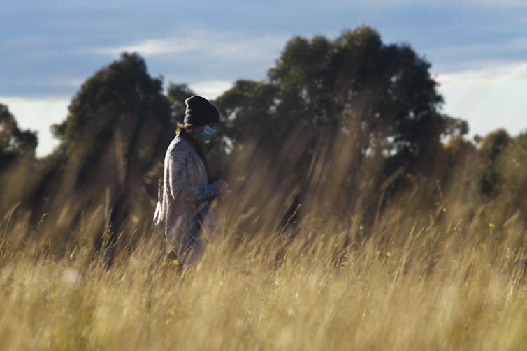 Woman walking in a field.