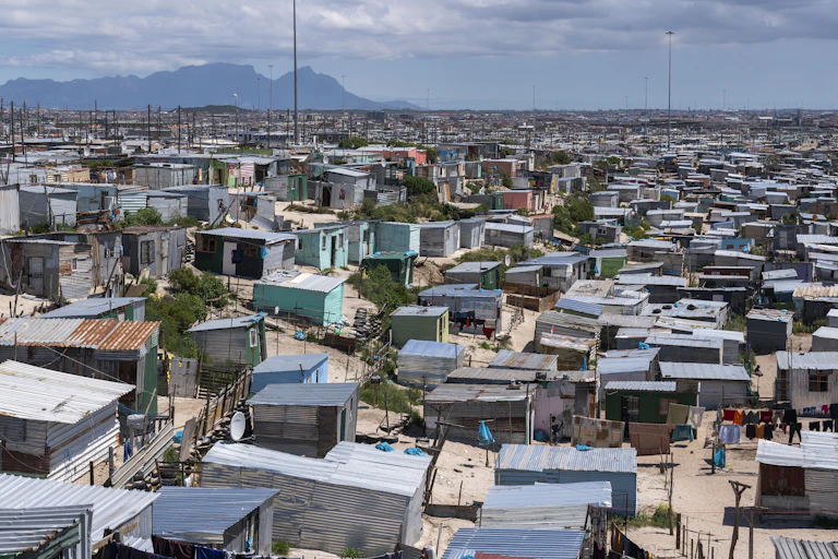 Hundreds of tiny shacks, some colourfully painted, and a mountain in the distance