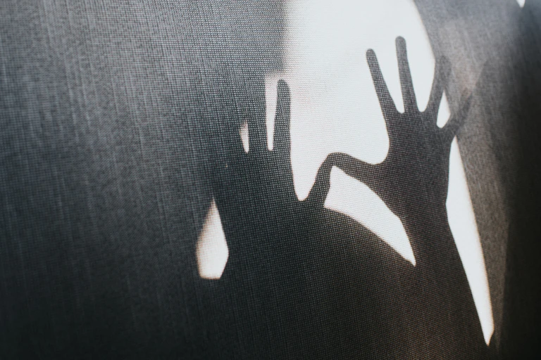 A silhouette of outstretched hands.