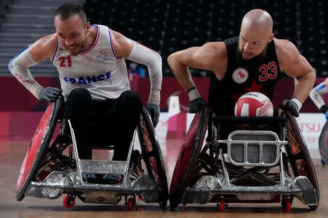 Two athletes in wheelchairs playing wheelchair rugby