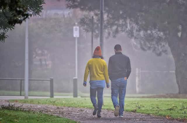 Couple walking in a park.