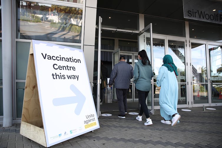 People walking into a vaccination centre
