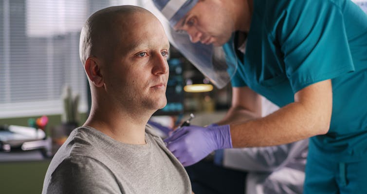 A man receives a vaccination.