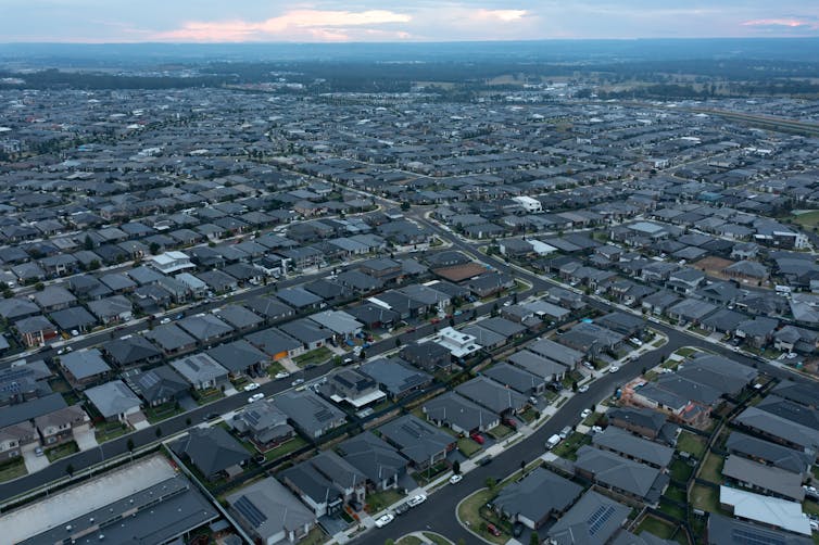 Sea of dark roofs stretching to horizon