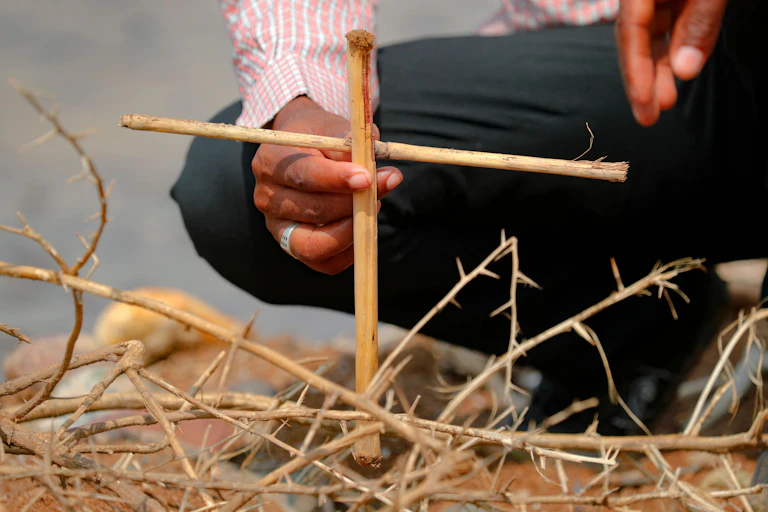 A cross made from twigs is planted on the ground