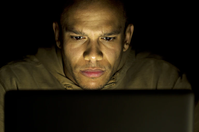 A man looking at a laptop