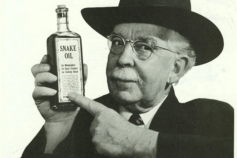 Man holding up a bottle of snake oil