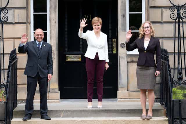 Scottish Green co-leaders Patrick Harvie, Nicola Sturgeon and Lorna Slater waving from the steps of Bute House. 