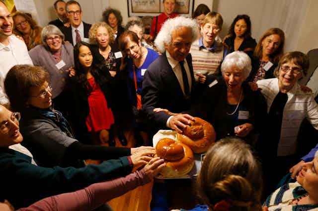 A congregation joins together for the kiddush during their observance of Rosh Hashana in Cambridge, Massachusetts in 2014.