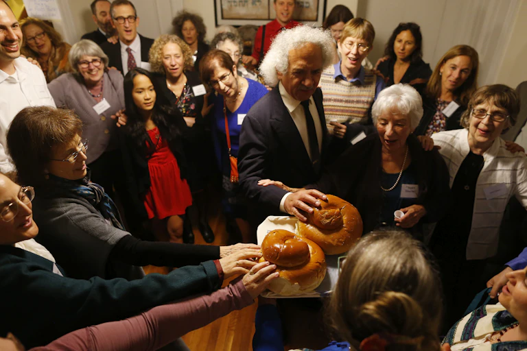 A congregation joins together for the kiddush during their observance of Rosh Hashana in Cambridge, Massachusetts in 2014.