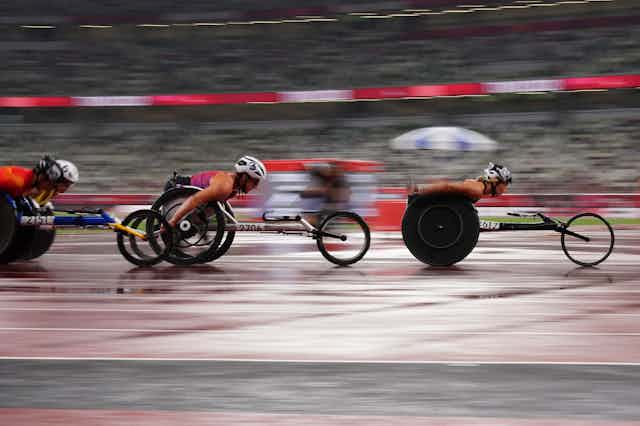 Wheelchair racer athletes racing across the track