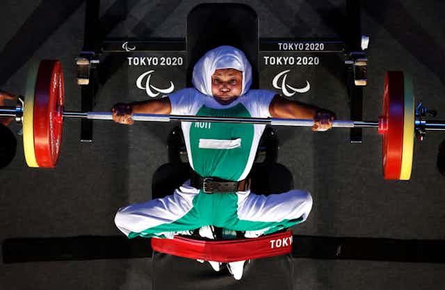 Paralympic powerlifter doing bench press, seen from above