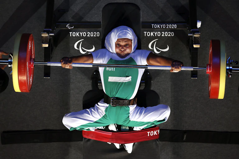Paralympic powerlifter doing bench press, seen from above