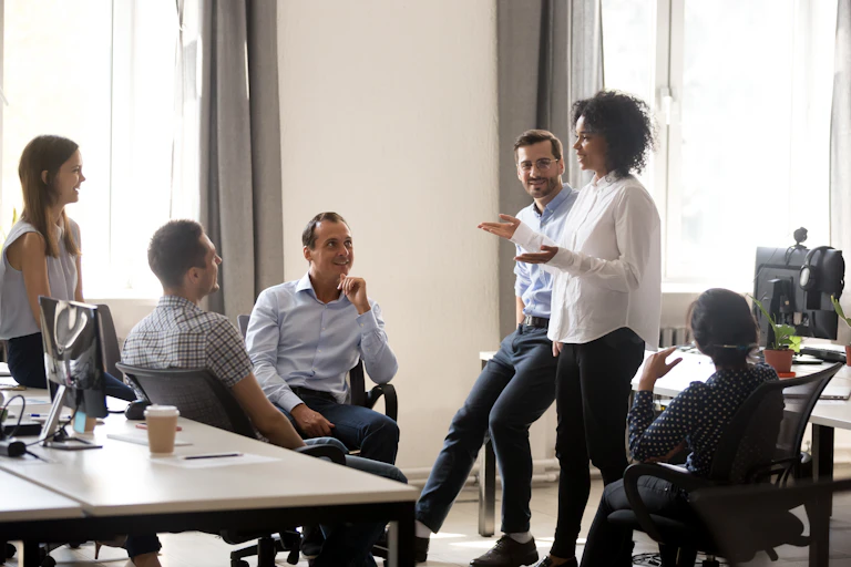 Mixed group of work colleagues chatting in a relaxed meeting