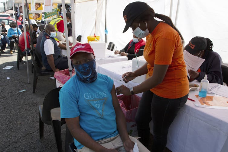 A man receives a COVID vaccination in South Africa.