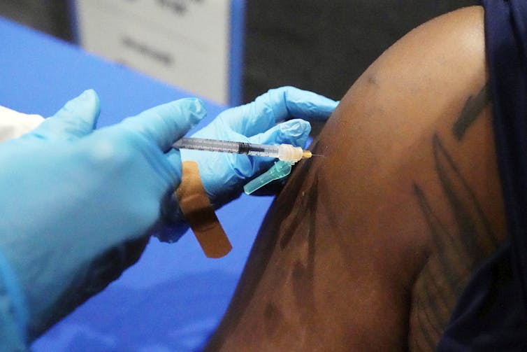 An arm getting an injection
