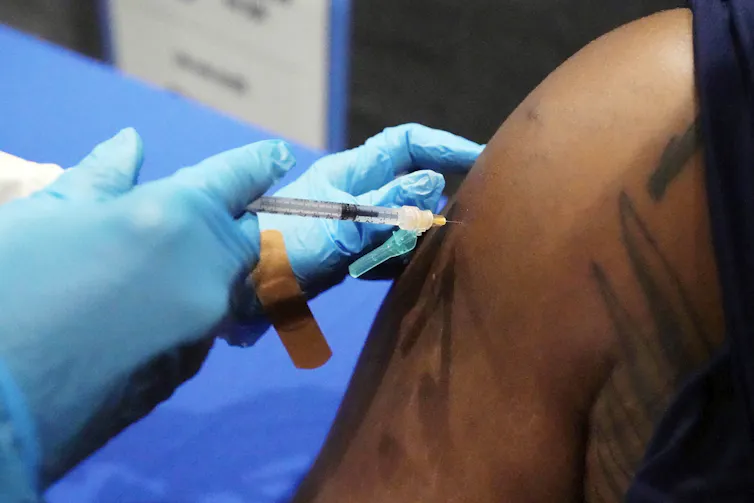 An arm getting an injection