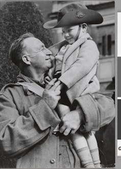 An Australian corporal reuniting with his son in Victoria in 1941 after an overseas deployment.