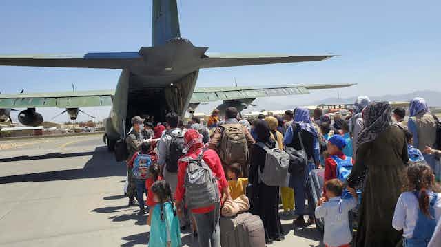 Afghan refugees preparing to board a South Korean flight in Kabul.