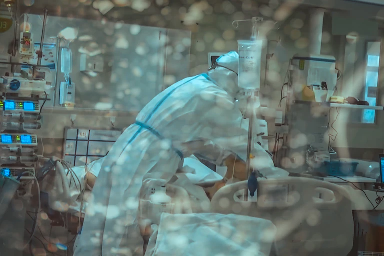 A nurse tending a patient in a Covid quarantine ward.