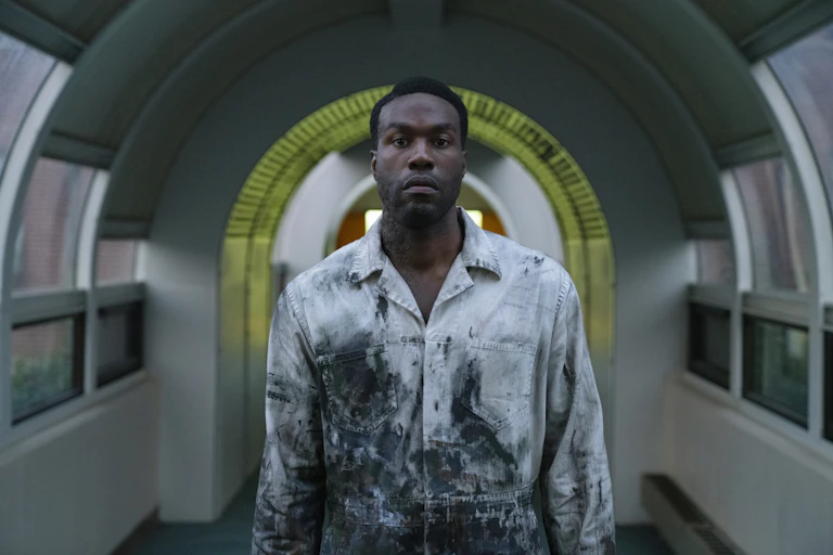 Man in tunnel wearing oil stained overalls