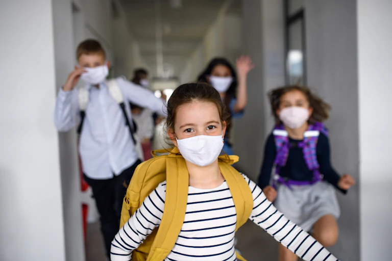 A group of children with masks on.