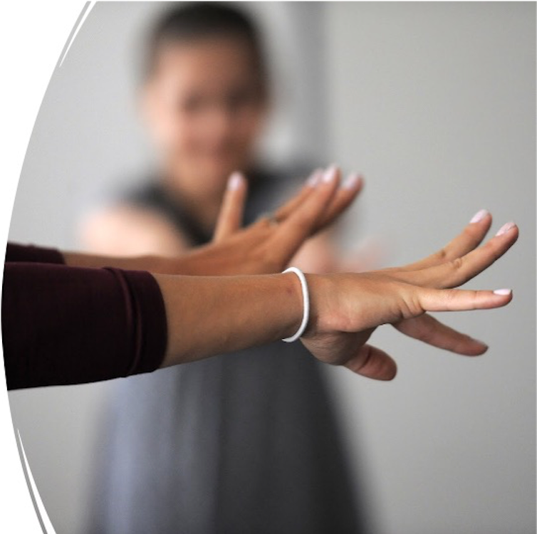 Neuroscientist Lana Ruvolo Grasser does a tension-and-release exercise with study participants.