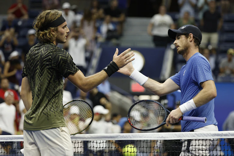 Stefanos Tsitsipas of Greece (L) and Andy Murray of Great Britain shake hands at the net.