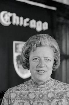 Portrait of Hanna Gray in front of a University of Chicago crest