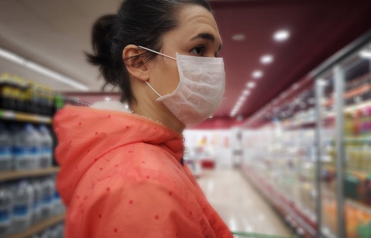 woman in grocery store wearing mask