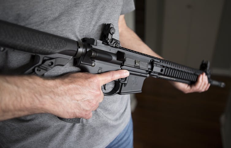 A restricted gun licence holder holds an AR-15.