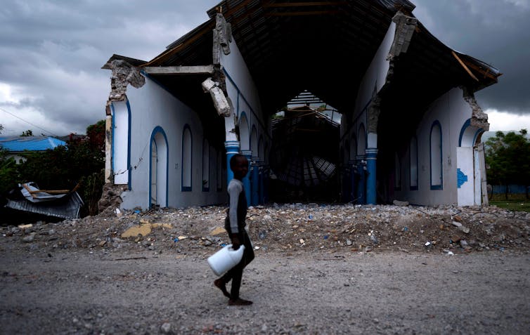 Boy walks past church with no frontage after earthquake.