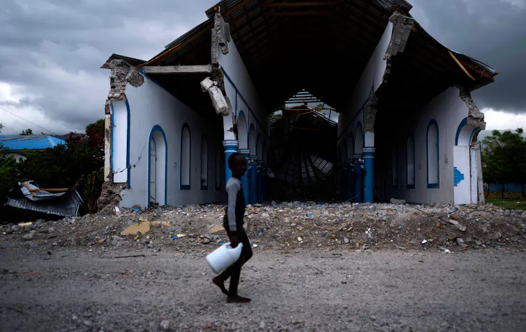 Boy walks past church with no frontage after earthquake.