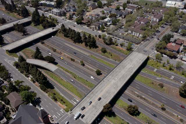 Highway with overpasses dividing neighborhoods.