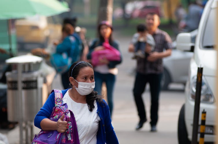 A Colombian woman wearing a facemask