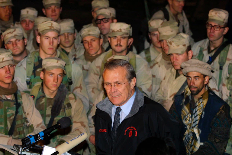 U.S. Secretary of Defense Donald Rumsfeld (C) addresses members of the 10th Mountain Division December 16, 2003 at Baghram Air Base in Afghanistan.