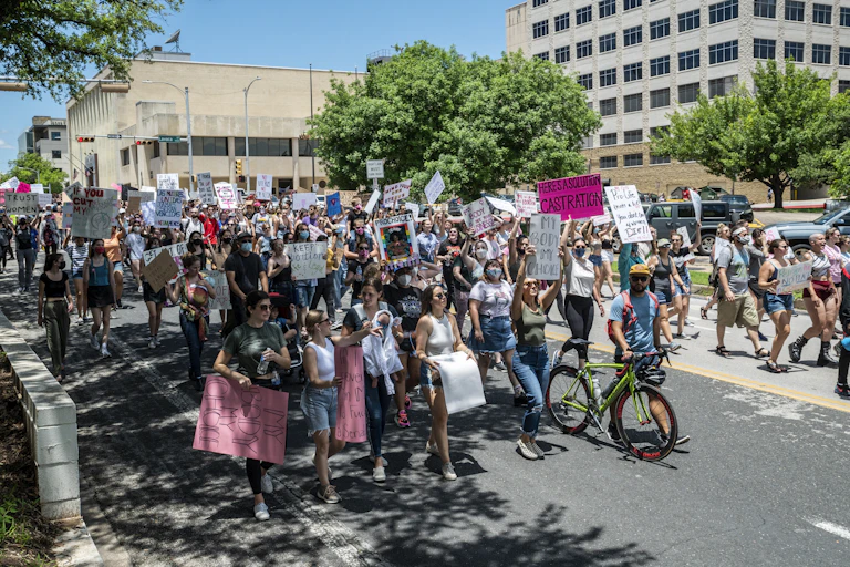 People protesting a Texas bill that outlaws abortions after a fetal heartbeat is detected march down a street to the state capitol in Austin on May 29.