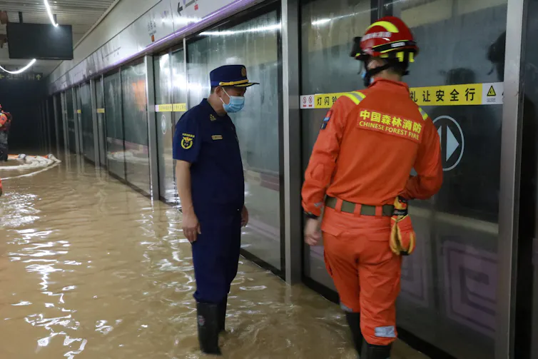 Firefighters pump rainwater from a flooded metro station in Zhengzhou, China