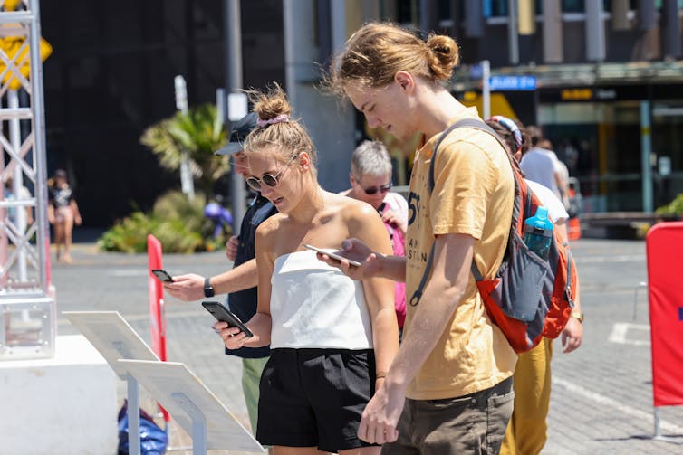 A group of people scanning in QR codes