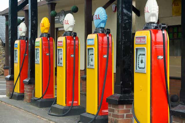 Five yellow and red retro petrol pumps.