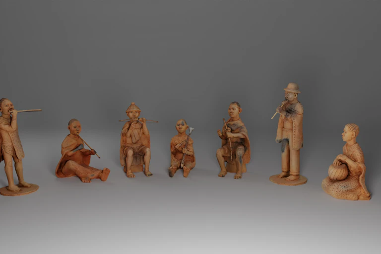 A row of seven clay figurines of people with musical instruments